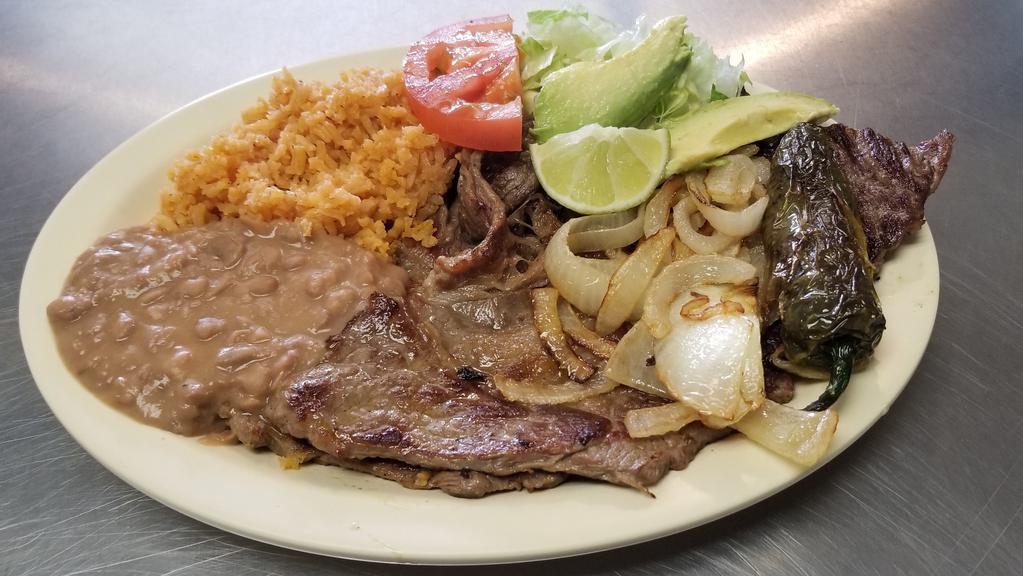 Carne Asada · Grilled steak topped with grilled onions.