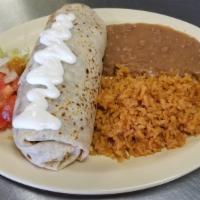 Burrito Dinner · Flour tortilla stuffed with choice of meat, beans, cheese topped with sour cream.