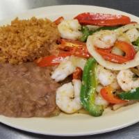 Shrimp Fajitas · Grilled shrimp sautéed with red and green peppers, onions and tomato served with rice and be...