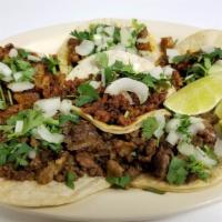 Tacos · Soft corn shells, filled with choice of meat along with onions and cilantro.