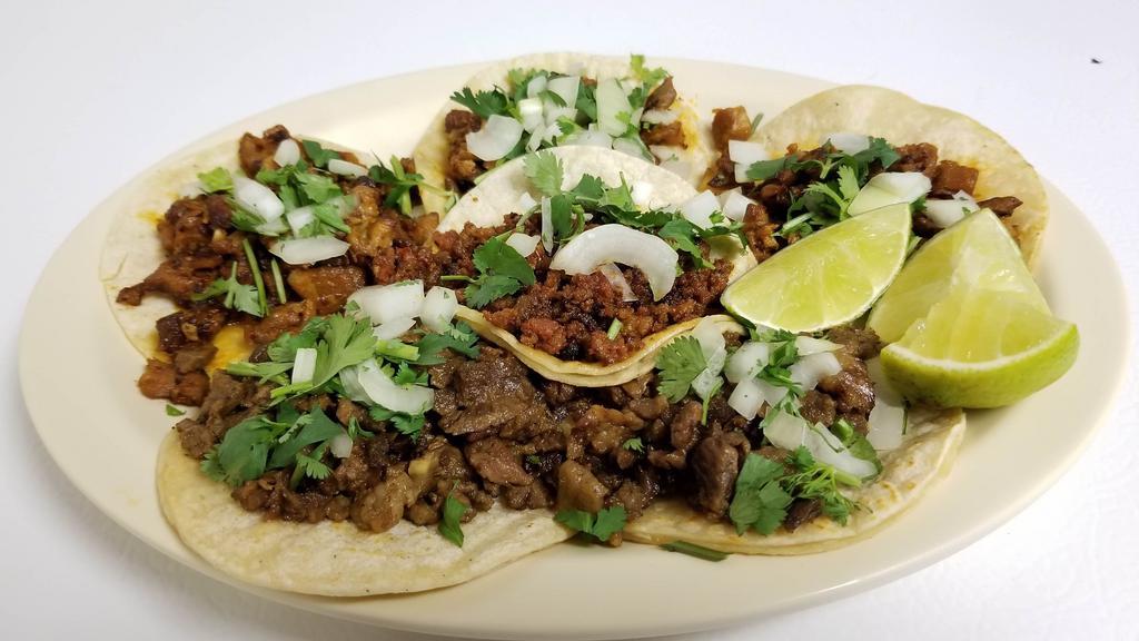 Tacos · Soft corn shells, filled with choice of meat along with onions and cilantro.