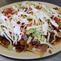 Nachos · Fresh nacho chips topped with choice of meat, along with beans lettuce, cheese, tomatoes, an...