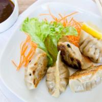Duck Gyoza · With scallions and plum soy dipping sauce.