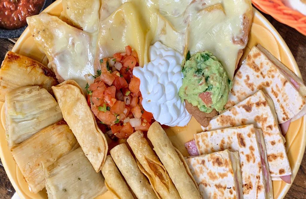 Botana Combinada · A super starter! A delicious appetizer combination consisting of nachos, ham quesadillas, tamales (pork and chicken), flautas (shredded beef and chicken) and a seafood empanada. Served with sour cream, guacamole and pico de gallo. Sorry, no substitutions, please.