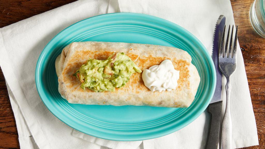 Burrito · Filled with beans, lettuce, tomato, and your choice of ground beef, chicken, flank steak, or pork (al pastor), topped with sour cream and guacamole.