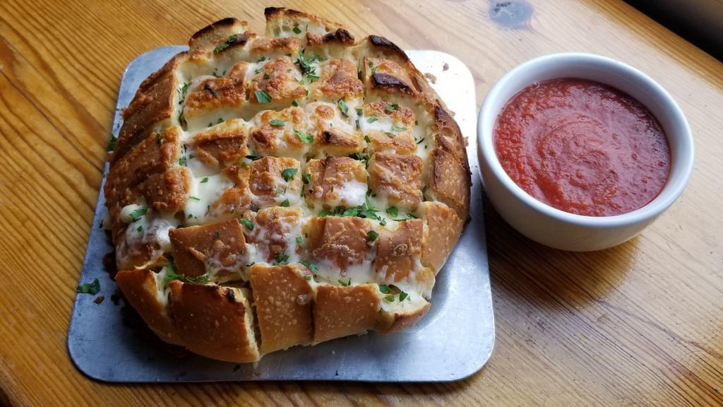 Cheesy Crack Bread · (VT) House blend of cheeses on fresh baked cracked bread, smothered in garlic herb butter, and served with a side of warm marinara