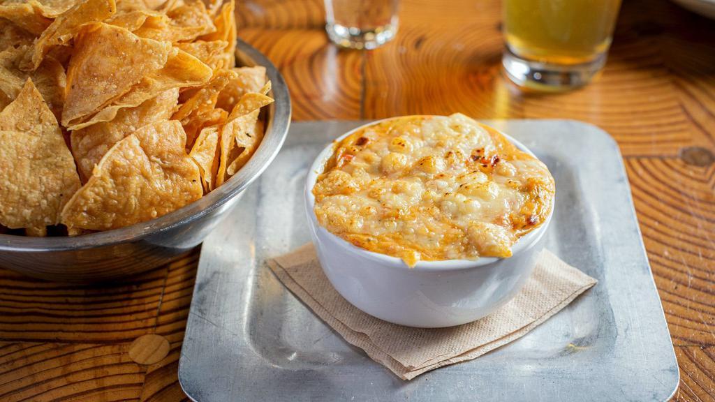 Spicy Corn Dip · (VT, GF) Creamy cheese blend with corn, diced peppers, jalapeno, onion, garlic, thyme, and cayenne. Comes with fresh fried corn tortilla chips.