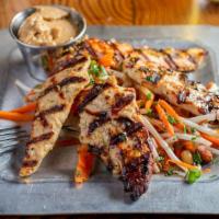 Grilled Chicken Satay · Thai marinated chicken tenders, sweet chili cucumber and carrot salad, serrano peppers, pean...