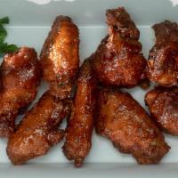 Chicken Wings · Seasoned in-house made wings tossed in your choice of Hot, BBQ or Thai Sauce