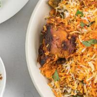 Chicken Tikka Biryani · Marinated chicken cooked in clay oven then pan fried with rice, herbs, spices and yogurt.
