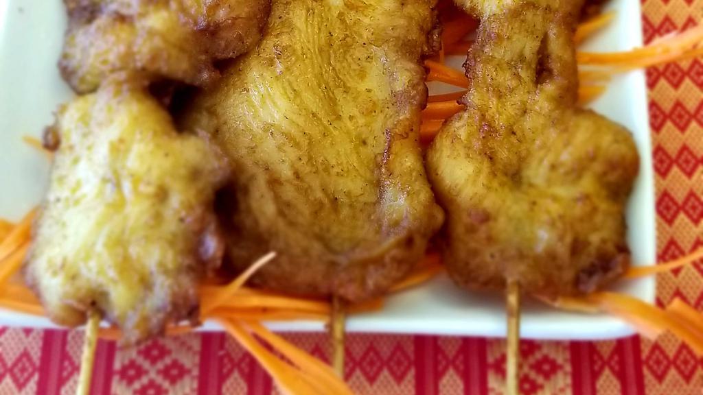 Chicken Satay · Grilled marinated sliced chicken on skewers.