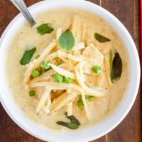 Green Curry · Green peas and bamboo shoots simmered in coconut milk, topped with fresh basil and sliced be...