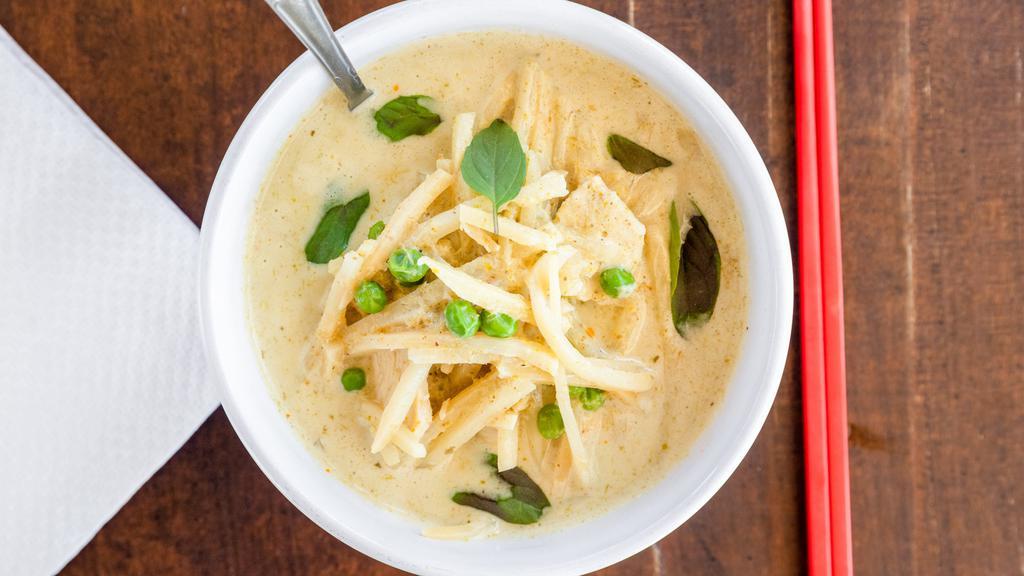 Green Curry · Green peas and bamboo shoots simmered in coconut milk, topped with fresh basil and sliced bell peppers.