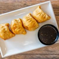 Fried Pot Stickers Dumplings · 4 big dumplings fried golden and served with our homemade dumpling sauce.