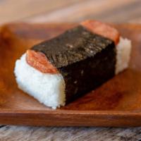 Spam Musubi · 2 pieces. A staple in Hawaii. Slice of spam on top of Japanese rice and wrapped in seaweed.