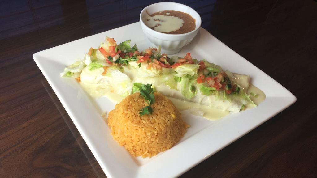 Lunch Special #17 (Cheese Steak Burrito) · Choice of steak or chicken with grilled onions, topped with lettuce, Pico de Gallo, cheese sauce and served with rice and beans.