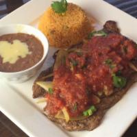 Steak Ranchero · Grilled steak with peppers, onions, tomatoes, topped with cheese and served with rice, beans...