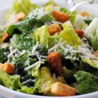 Caesar · Romaine lettuce, croutons, parmesan cheese and our classic Caesar dressing, topped with anch...