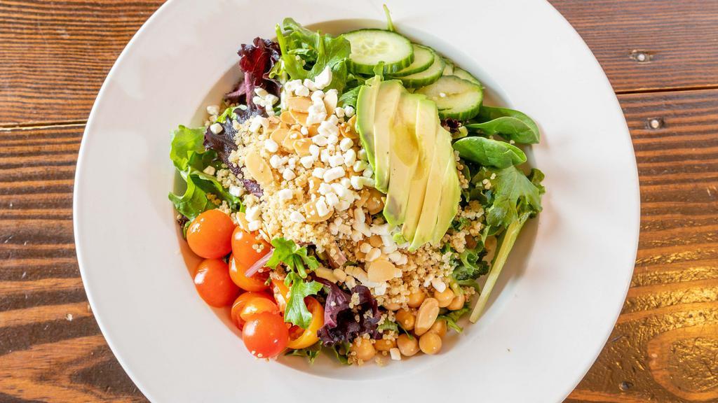 Quinoa Salad ** · Mixed greens, fresh herb vinaigrette, garbanzo beans, cucumber, grape tomatoes and red onion, quinoa, avocado, goat cheese, and toasted almonds.