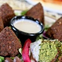Falafel · 6 pieces. Chickpeas and 5 beans ground with vegetables and spices. Served with tahini sauce,...