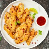 Sweet Chili Wings · Fresh chicken wings breaded, fried until golden brown, and tossed in sweet chili sauce. Serv...