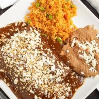 Enchiladas De Mole · Soft rolled tortillas filled with chicken simmered in mole sauce topped with crumbled Mexica...