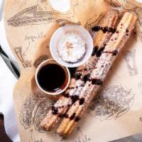 Churro Y Chocolate · Crisp Mexican doughnuts with a rich chocolate sauce.