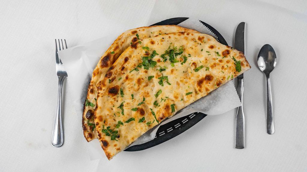 #17. Garlic Naan · Tandoori naan topped off with seasoned garlic.