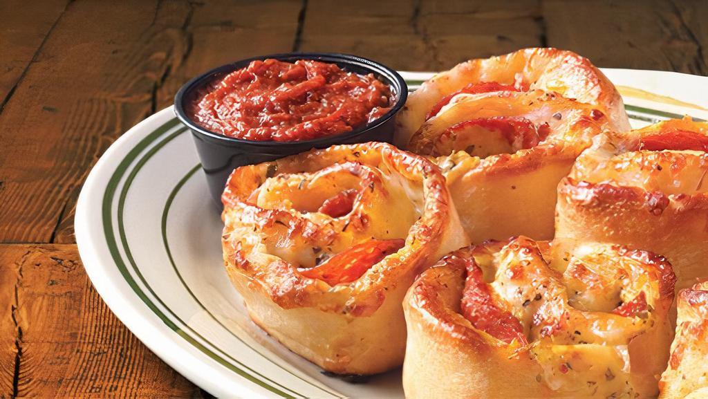 Pepperoni Rondos · Oven-baked blossoms of pizza dough brushed with garlic-pesto sauce, stuffed with provolone cheese and pepperoni. Pizza sauce for dipping. 6 servings.