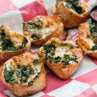 Spinach Rondos · Oven-baked blossoms of pizza dough brushed with garlic-pesto sauce, stuffed with provolone c...