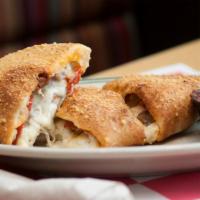 Three Meat Calzone · Filled with our 4-cheese blend and stuffed with pepperoni, sausage and capocolla ham. Served...