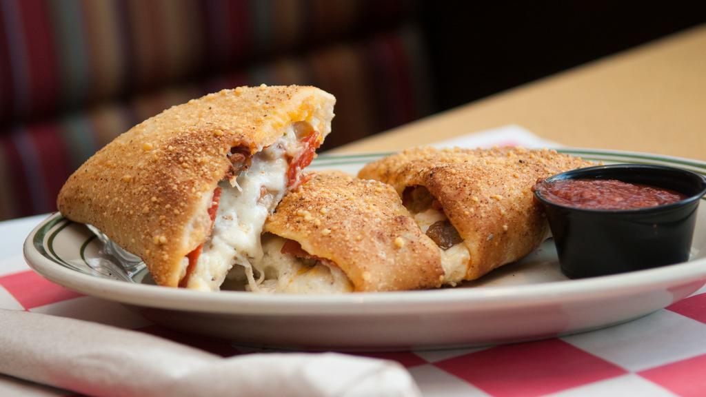 Three Meat Calzone · Filled with our 4-cheese blend and stuffed with pepperoni, sausage and capocolla ham. Served with Family Recipe Pizza Sauce cup for dipping.