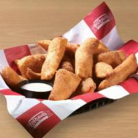 Cinnamon Dippers · Strips of fried dough sprinkled with cinnamon and sugar, served with icing for dipping.