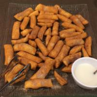 Tray Cinnamon Dippers · Strips of fried dough with sugar and cinnamon with icing for dipping. (Feeds 10.)