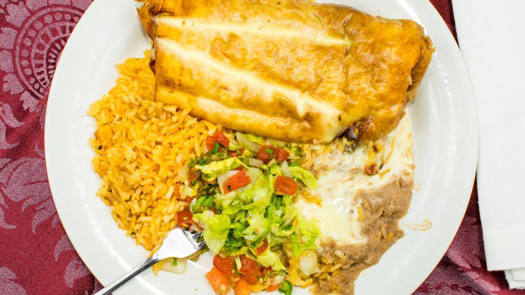 Lunch Chimichanga · Flour tortilla deep-fried, filled with beef tips or chicken, topped with lettuce, tomatoes, cheese, sour cream and guacamole served with fried beans.