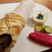 Kafta · Grilled Beef with Spices, hummus, tomatoes, pickles, and onions.