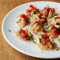 Jorge'S Nachos · Tuna, salmon, and yellowtail with yuzu koshu on crispy wonton chips, topped with cilantro, f...