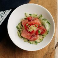 Tuna Poké · Marinated cubed ahi on a bed of cucumber salad topped with wasabi tobiko.