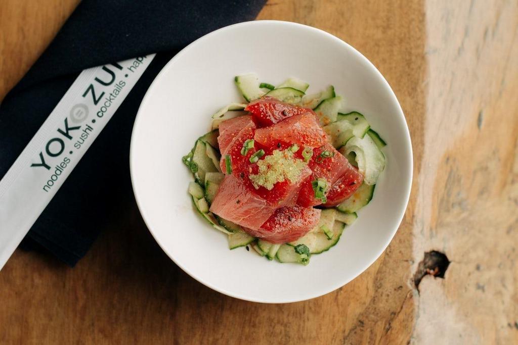 Tuna Poke · Marinated cubed ahi on a bed of cucumber salad topped with wasabi tobiko.