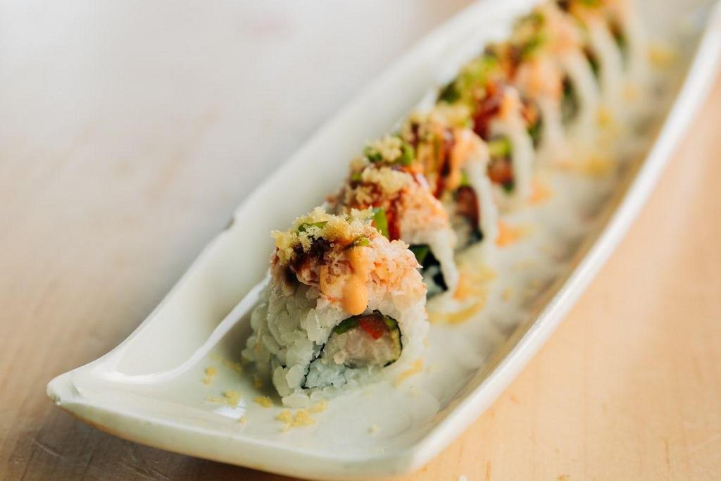 *The Flaming Lips · Yellowtail, jalapeño, avocado, red bell pepper topped with snow crab, tempura crunchies, sweet evil and spicy mayo, and scallions.