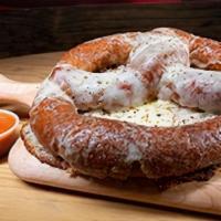 Pizza Pretzel · Ball park style pretzel toped with mozzarella cheese, baked in the oven then sprinkled with ...
