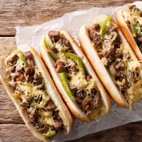Philly Cheesesteak · The perfect Philly cheesesteak with green pepper, artfully sautéed onions, and fresh lettuce...