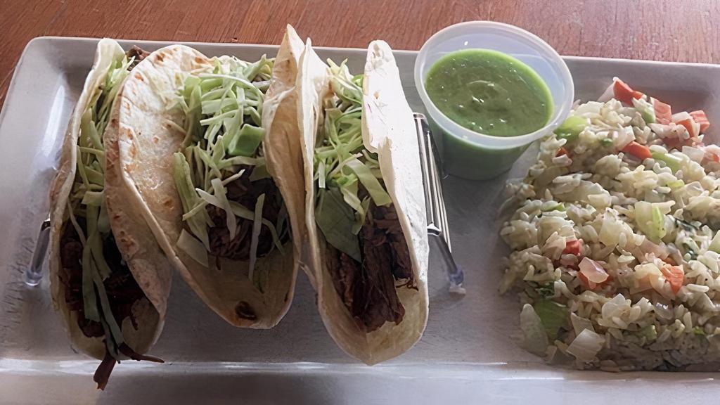 Short Rib Tacos · Topped with green cabbage and served with a side of salsa verde and Spanish rice.  Add a soup or house salad for a buck!