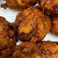 Vegetable Pakora · Seven pieces. Sliced onions, potatoes mixed with chickpeas flour, and fried until golden bro...