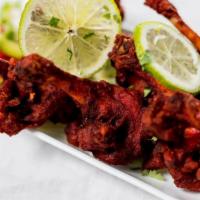 Chicken Lollipops · Six pieces. Chicken pulled back, coated in spicy red batter and deep.