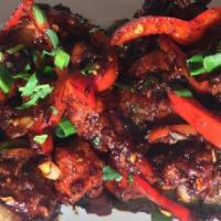 Chilli Chicken · Stir fried boneless chicken with sweet bell peppers, green chilies, onions, and aromatic Ind...