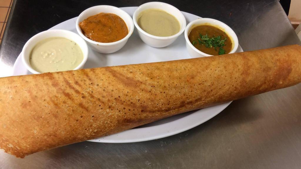 Masala Dosa · Rice and lentil crepes topped with onion and herbed potato curry. Served with lentil soup and chutney.