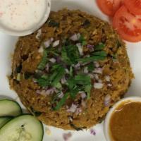 Veg Kothu Parotta · Street style Indian layered bread with vegetables. Served with lentil soup and chutney.