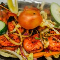 Tandoori Shrimp · Jumbo prawns marinated in yogurt, ginger garlic paste with special herbs and spices. Cooked ...