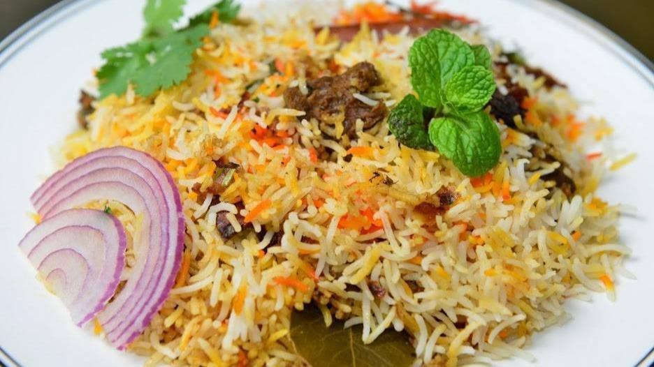 Lamb Biryani · Lamb marinated in spices and herbs and cooked with saffron flavored aromatic basmati rice. Spiced to order and served with whipped yogurt sauce blended with herbs and finely grated cucumbers. Served with raita and salan.